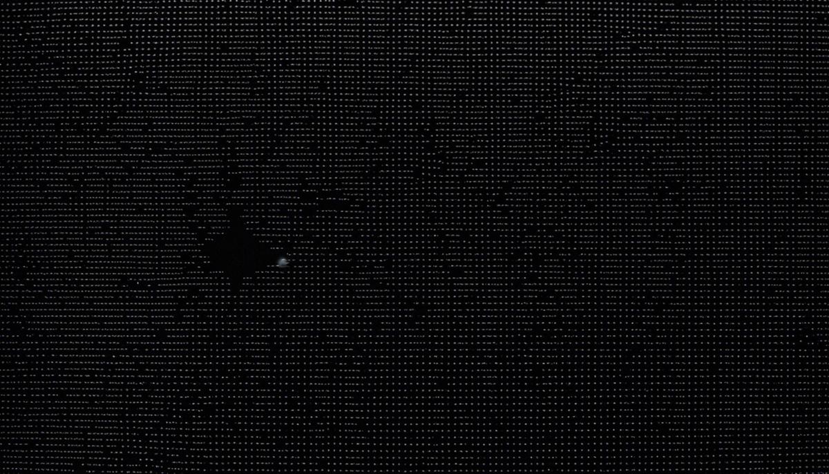 A close-up image of a black spot on a laptop screen